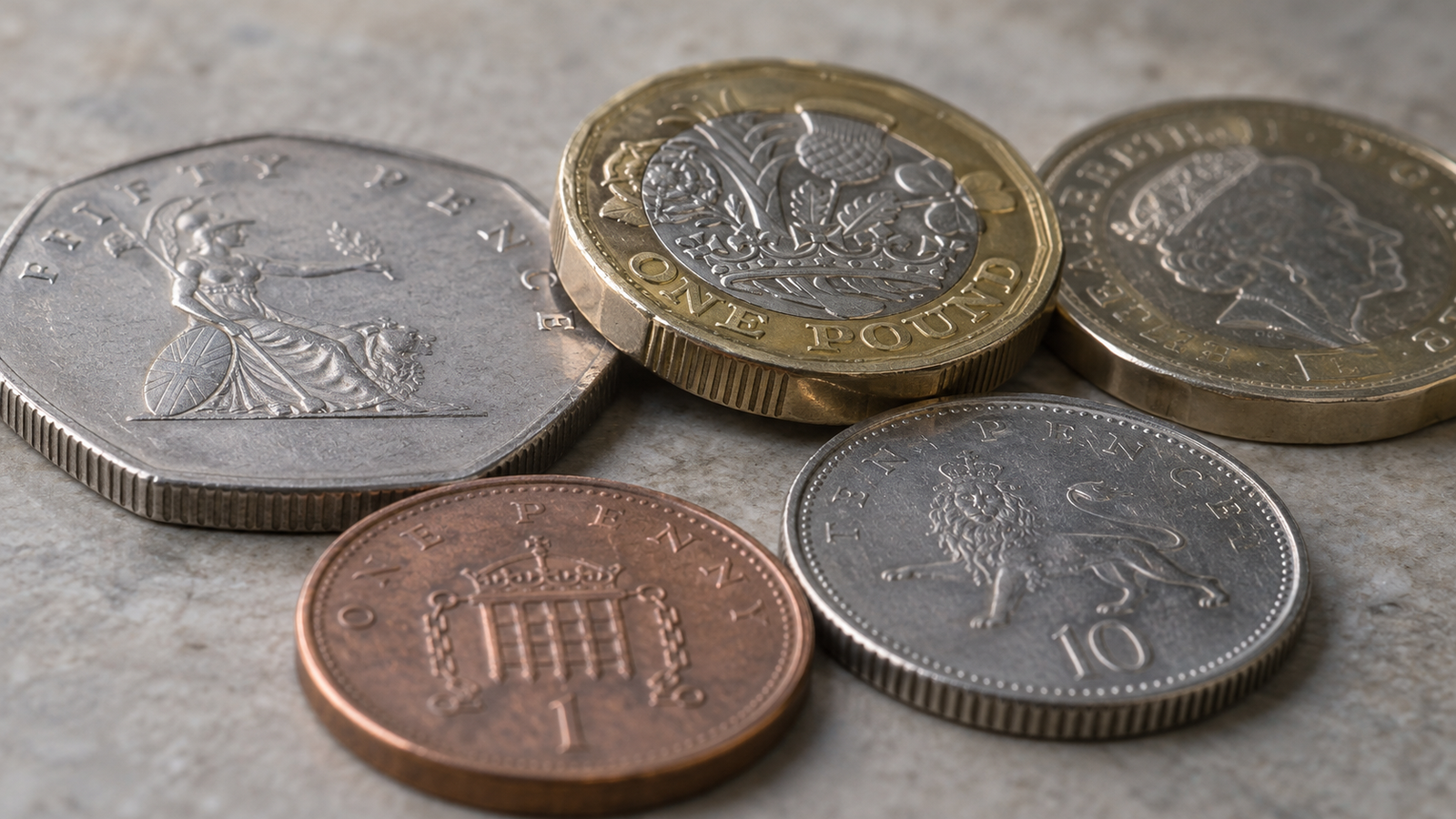 Close-up view showing the ridged and plain edges of several British coins